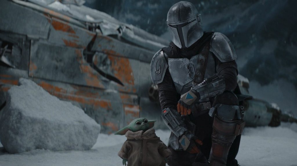 The Mandalorian and Baby Yoda get close to each other in front of a damaged ship in the snow as seen in Chapter 10.