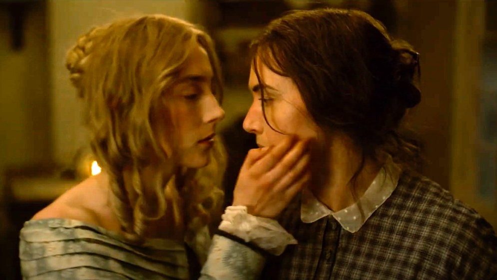 Kate Winslet and Saoirse Ronan closely lock faces before an intimate kiss as seen in Ammonite. 