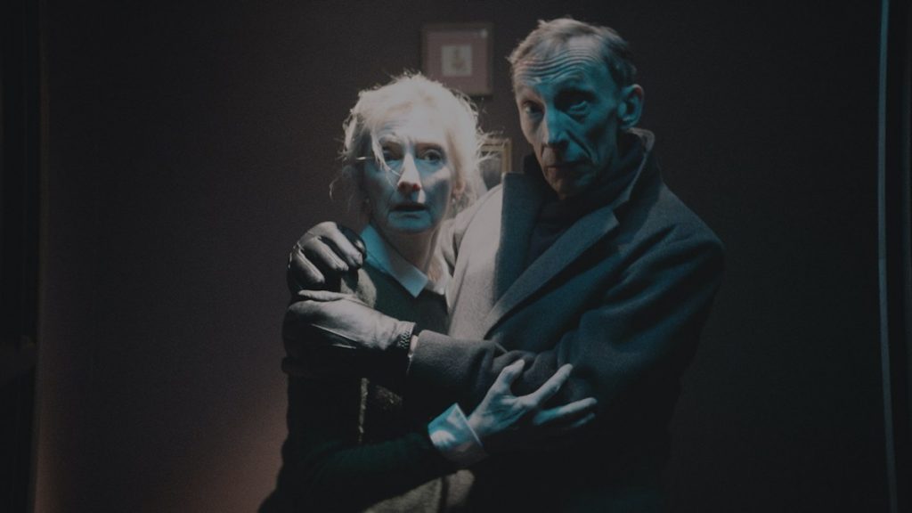 Sheila McCarthy and Julian Richings hold each other in fear and shock as seen in the Shudder exclusive Anything for Jackson.