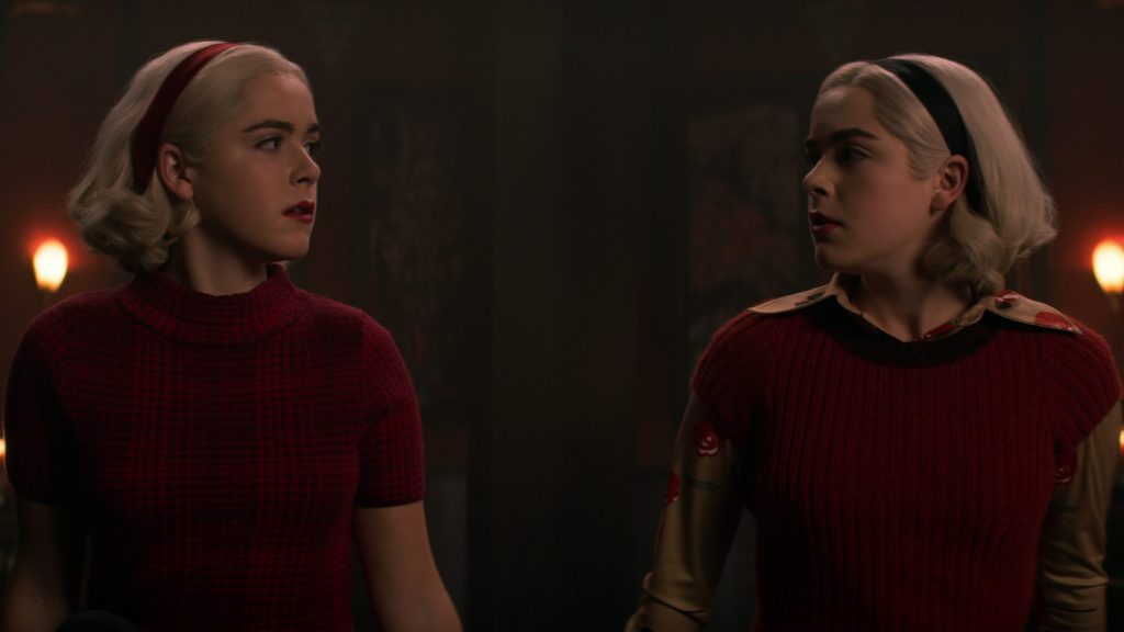 Kiernan Shipka as the two versions of Sabrina the teenage witch as seen in season 4 of The Chilling Adventures of Sabrina.