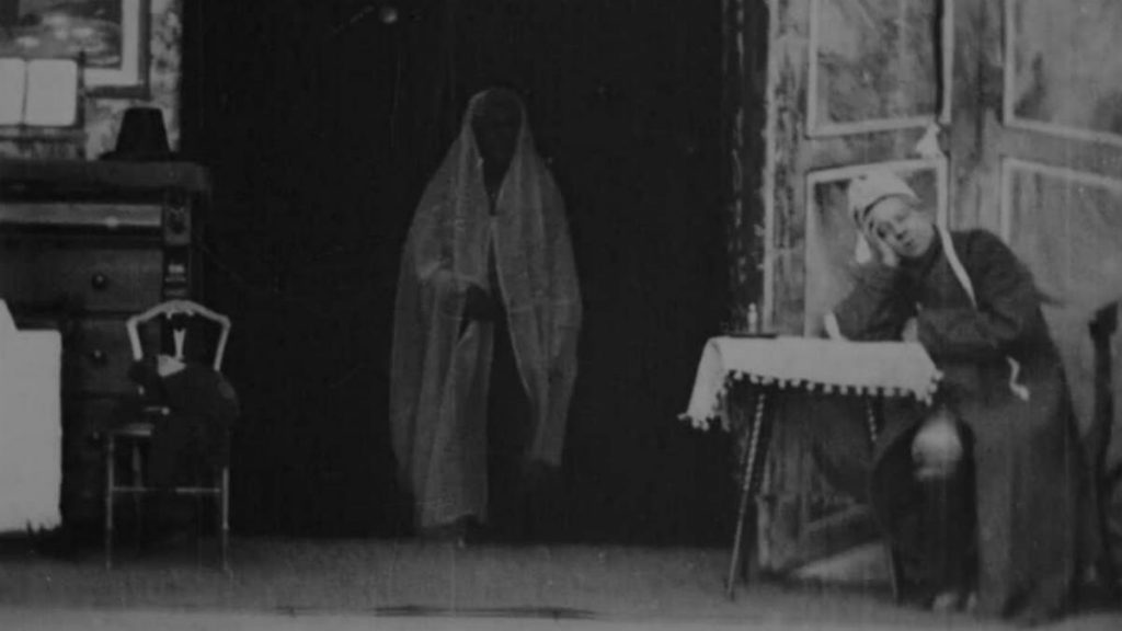 The Ghost of Christmas Future visiting Ebeneezer Scrooge in the first black and white and silent film adaption from 1901 titled Scrooge, or Marley’s Ghost.