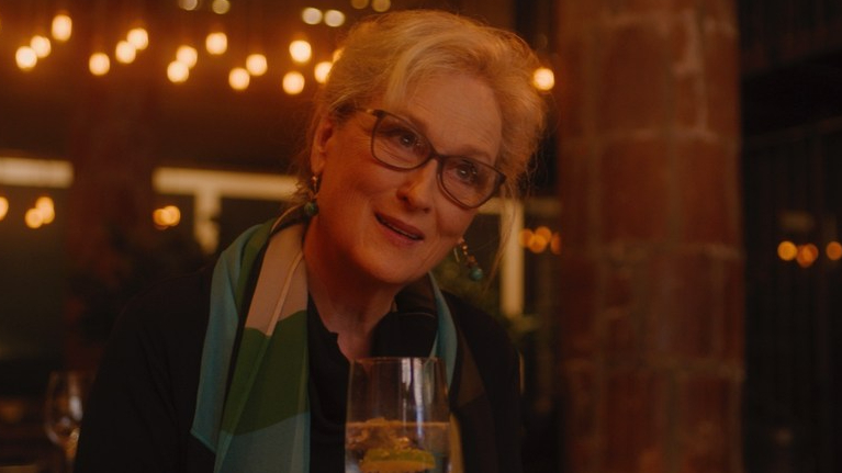 Meryl Streep sitting in a dim restaurant as seen in Let Them All Talk exclusive to HBO Max.