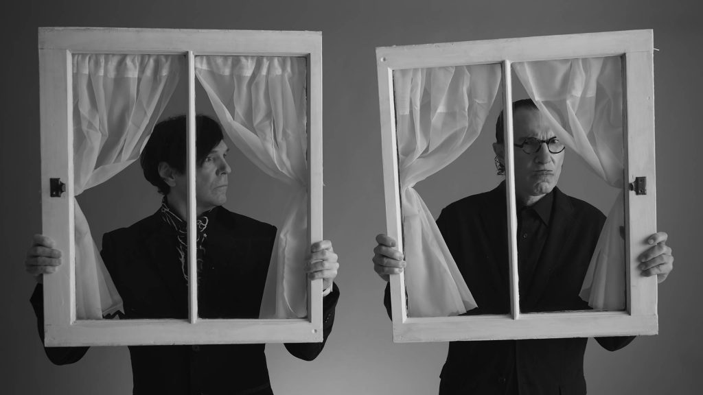 The Sparks Brothers holding fake windows to their faces as seen in Edgar Wright's documentary debut, an official 2021 Sundance selection.
