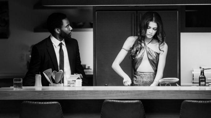 A still of John David Washington and Zendaya wearing fancy clothes in a simple kitchen as seen in Malcolm & Marie, a film scheduled with a 2021 release date from Netflix. 