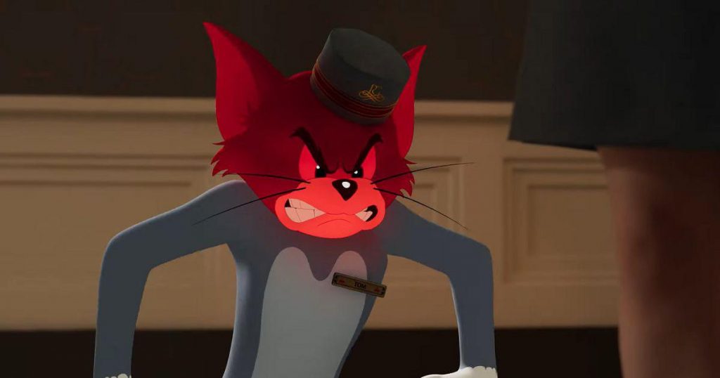 Tom wearing a bellhop hat with a bright red face full of anger as seen in the 2021 film Tom & Jerry.