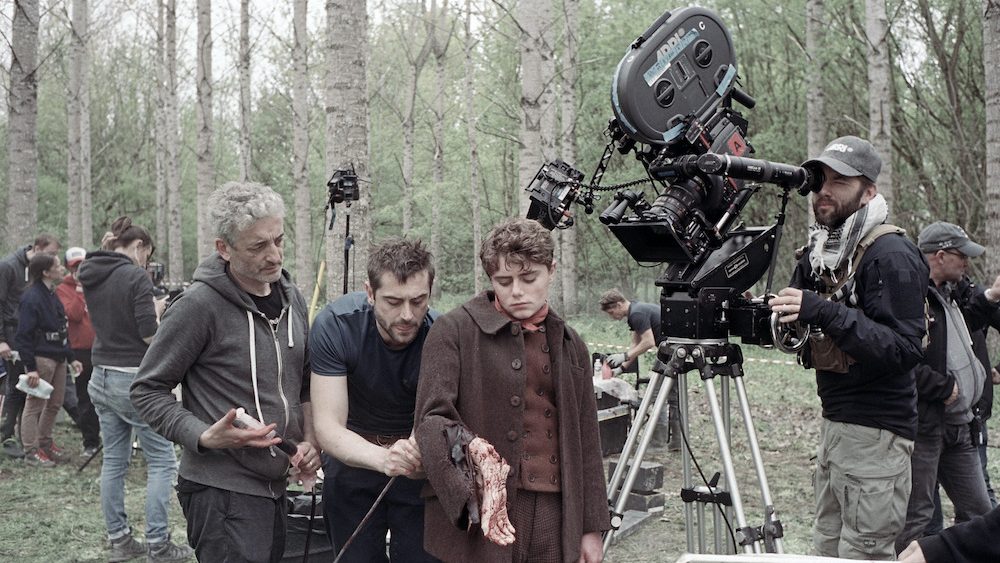 Sean Ellis using a camera to direct a scene with gore and practical effects on the set of Eight for Silver. 