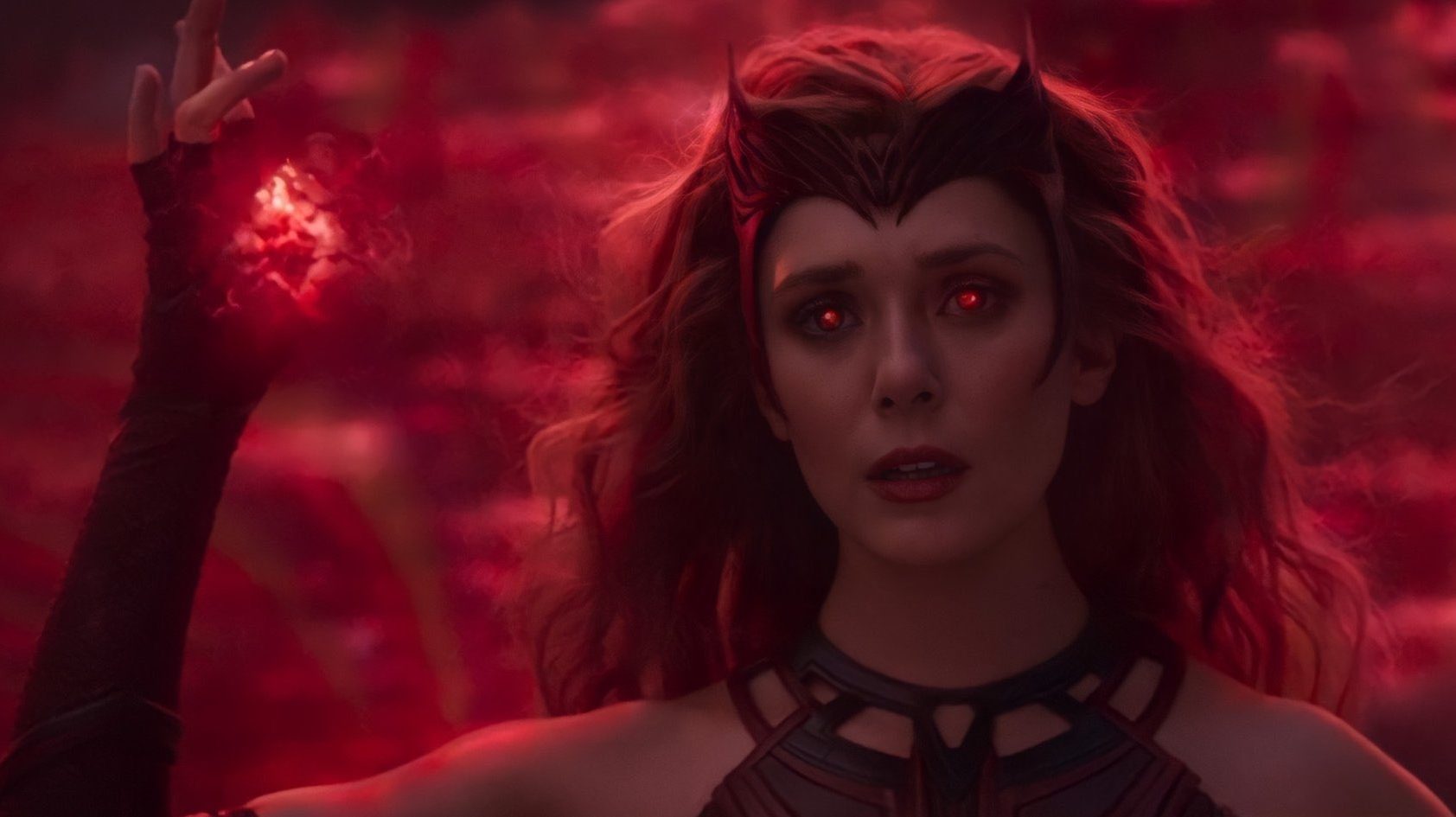 Wanda Maximoff glows with red power and finally becomes the Scarlet Witch as seen in the series finale of WandaVision.