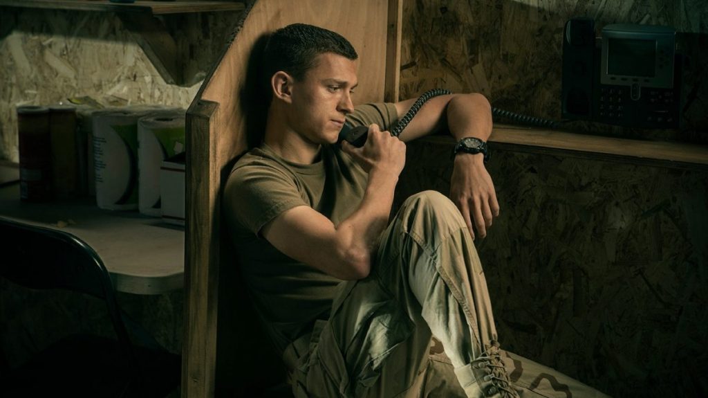 Tom Holland looking sad on the phone in an army based as seen in Cherry directed by the Russo Brothers. 