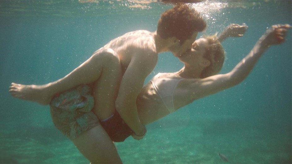 Sebastian Stan and Denise Gough kissing passionately underwater as seen in the film Monday. 