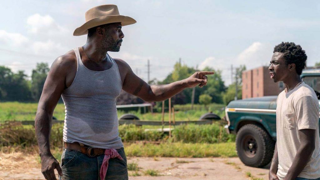Idris Elba and Caleb McLaughlin on an urban ranch as seen in the Netflix film Concrete Cowboy directed by Ricky Staub. 