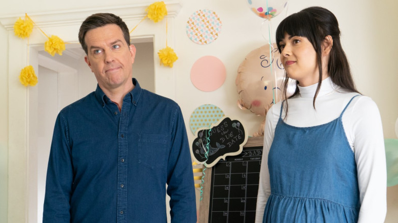 Ed Helms and Patti Harrison standing next to each other in a baby's room as seen in the new dramatic comedy Together Together.