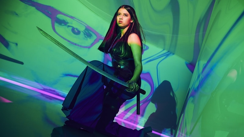 Amber Midthunder wielding a sword in front of a psychedelic backdrop as seen in FX's Legion, she will next star in the upcoming new Predator film.