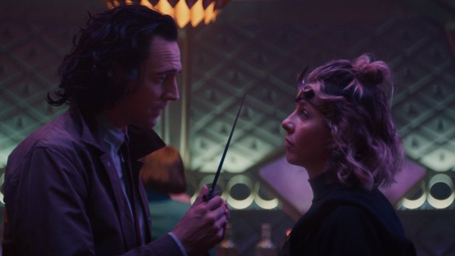 Tom Hiddleston as Loki holds a dagger to Sophia Di Martino as Lady Loki aka Sylvie on a fancy train as seen in Episode 3 of LOKI on Disney+.