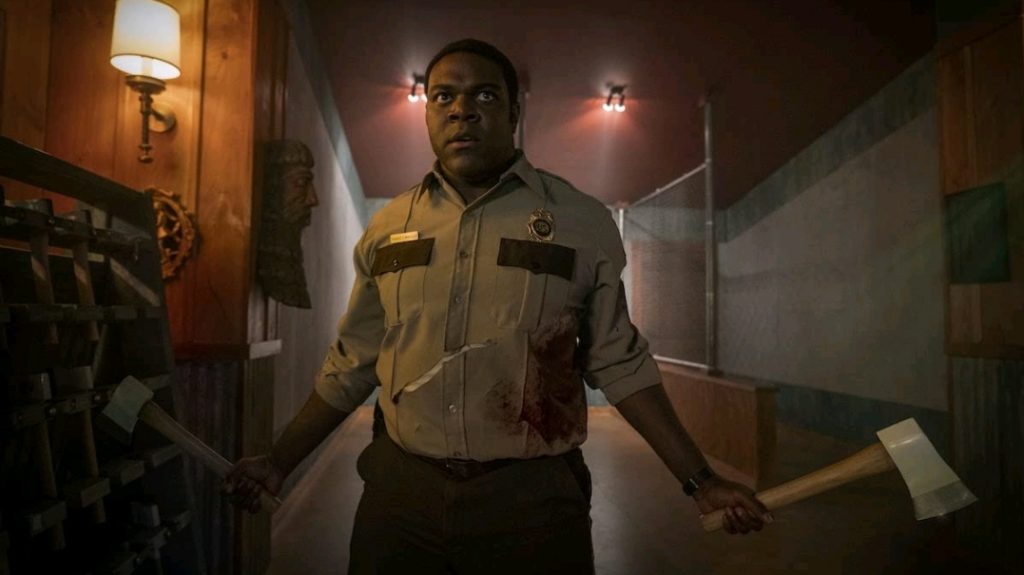 Sam Richardson with two silver axes in hand as seen in the new Horror Comedy WEREWOLVES WITHIN.