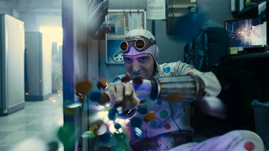 David Dastmalchian as Polka-Dot man shooting colorful explosive polka dots out of his arm as seen in THE SUICIDE SQUAD directed by James Gunn.