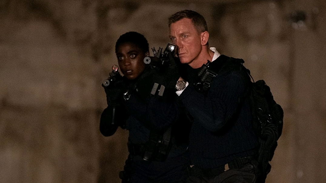 Lashana Lynch and Daniel Craig infiltrating a secret island base in NO TIME TO DIE directed by Cary Fukunaga.