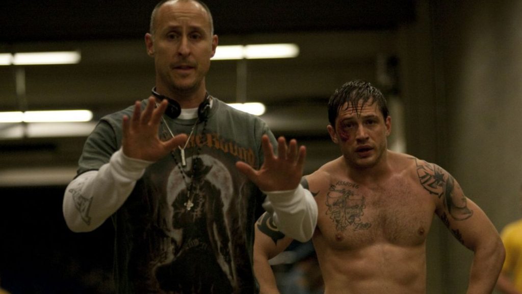 Director Gavin O'Connor on the set of WARRIOR with Tom Hardy bruised and bleeding in full MMA gear.