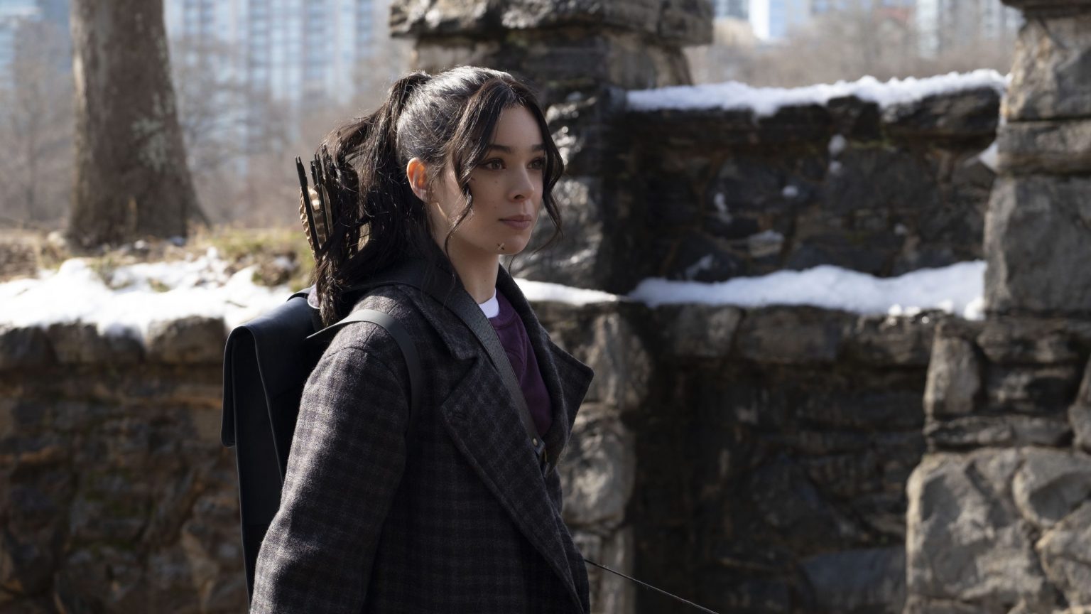 Hailee Steinfeld as Kate Bishop sporting a quiver full of arrows in a snowy New York park as seen in the new Marvel series on Disney+ HAWKEYE.