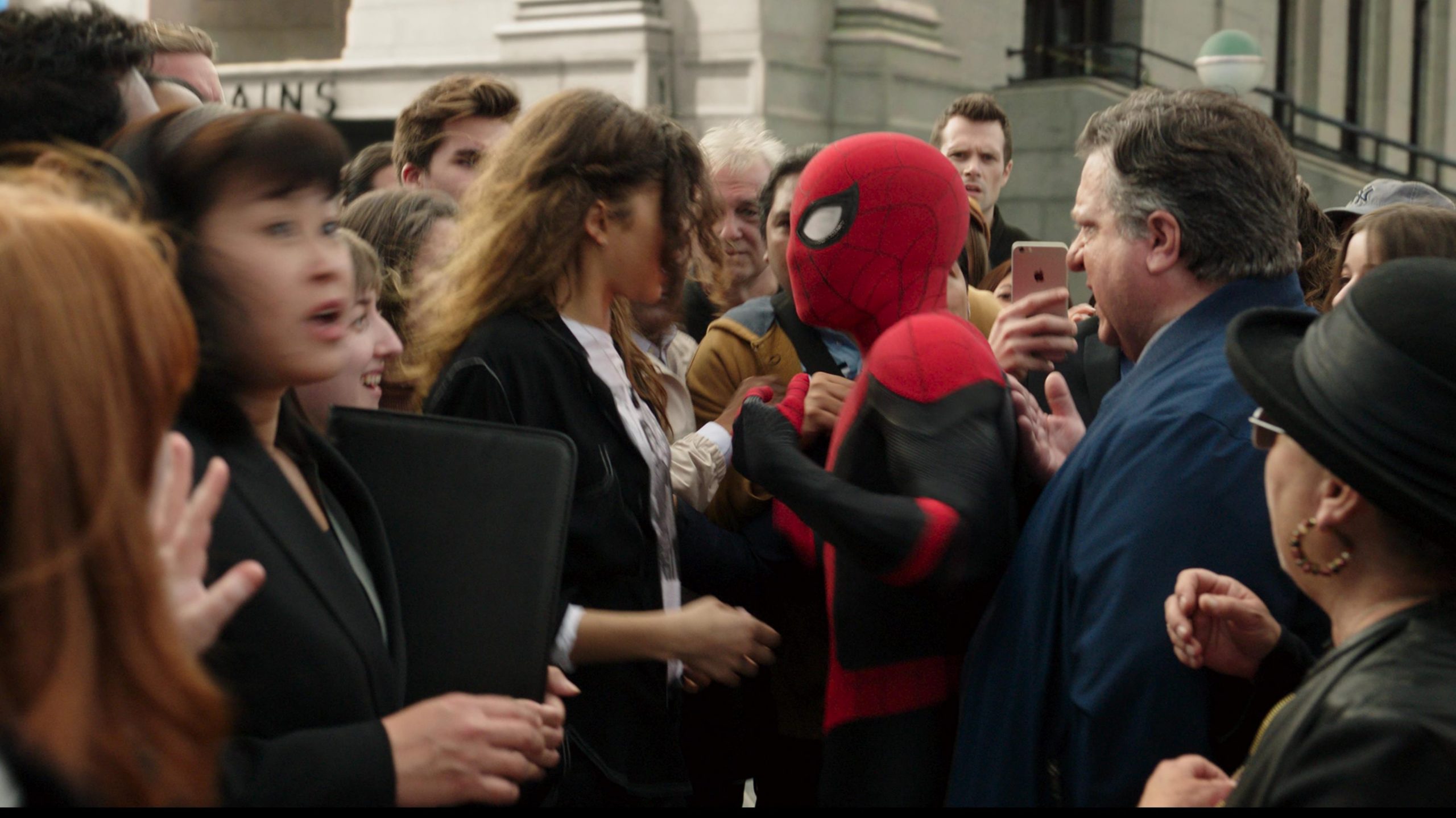 Spider-Man and MJ are rushed by a crowd of New Yorkers as Peter Parker's identity is revealed as seen in SPIDER-MAN: NO WAY HOME written by Chris McKenna and Erik Sommers. 