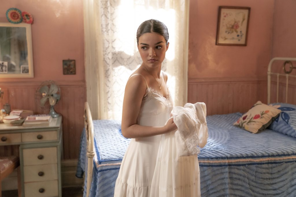 Rachel Zegler as Maria glows in a white gown in a small New York apartment as seen in WEST SIDE STORY (2021) directed by Steven Spielberg.
