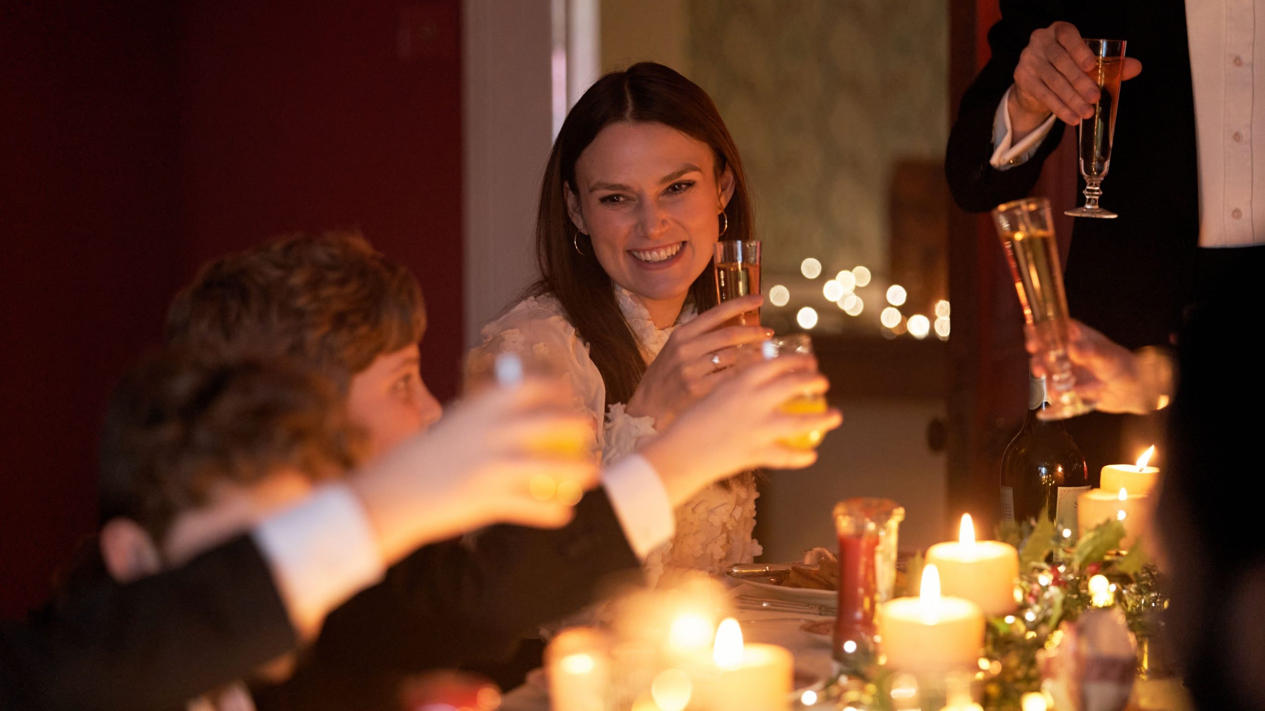 Keira Knightley and her family raise a toast to the apocalypse at a fancy holiday dinner as seen in the new horror comedy SILENT NIGHT. 