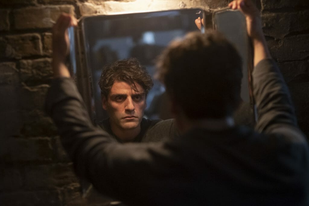 Oscar Isaac stares his other identity in the mirror as seen in Marvel's Moon Knight on Disney+