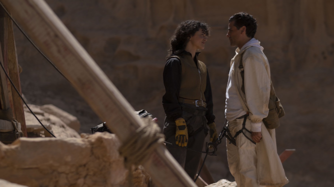 May Calamawy and Oscar Isaac share a moment together while strapped to climbing gear in the Cairo desert in the new MCU series on Disney+ MOON KNIGHT. 