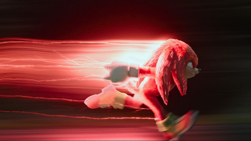 Knuckles the Echidna voiced by Idris Elba runs at super speed with a red streak of lightning following behind him in SONIC THE HEDGEHOG 2 directed by Jeff Fowler.