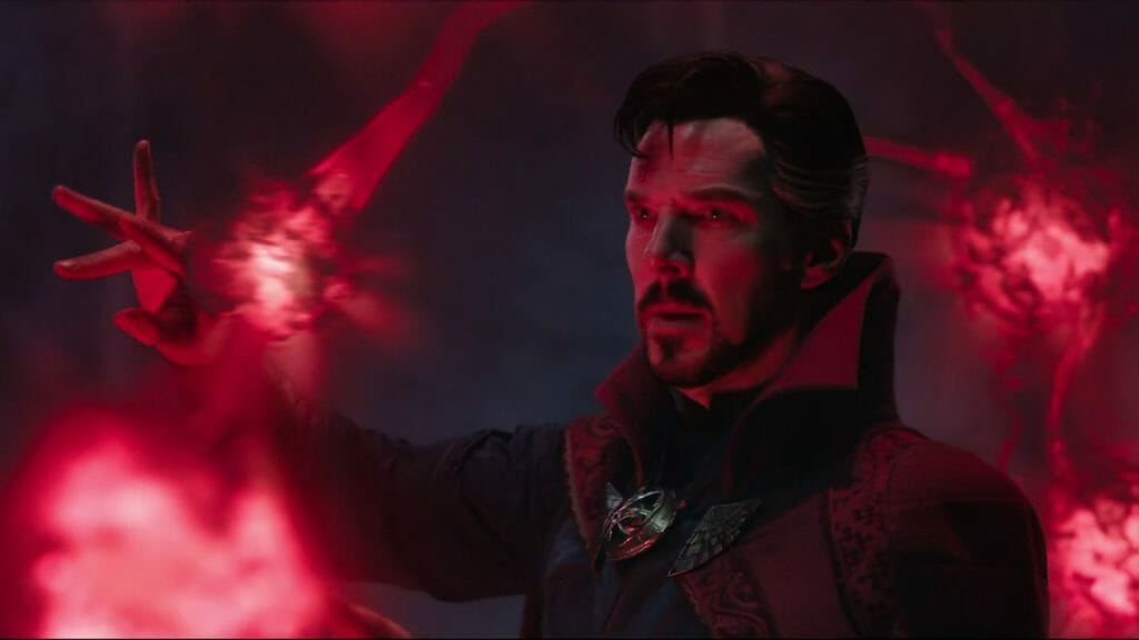 A close up of Benedict Cumberbatch as Doctor Strange as he summons dark red orbs of magic to do a dream walking spell in DOCTOR STRANGE IN THE MULTIVERSE OF MADNESS directed by Sam Raimi.