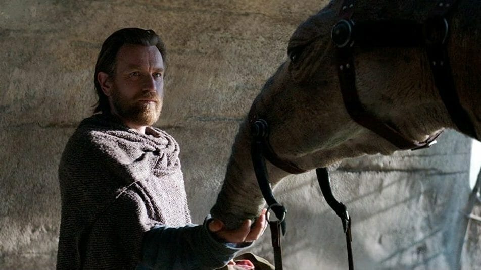 Ewan McGregor as Obi-Wan Kenobi attends to a space camel called an Eopie in the new Star Wars series premiering in May 2022 on Disney+.