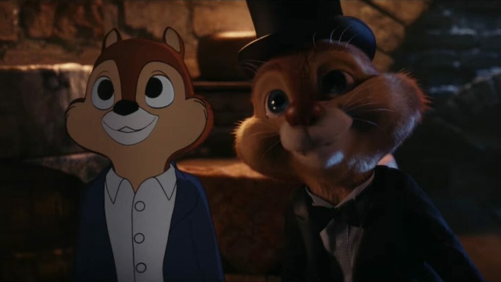 Chip in his classic 2D form and Dale in his new 3D animated form wearing a top hat and tuxedo pose together in the secret dungeon of a cheese shop in CHIP 'N DALE: RESCUE RANGERS on Disney+.