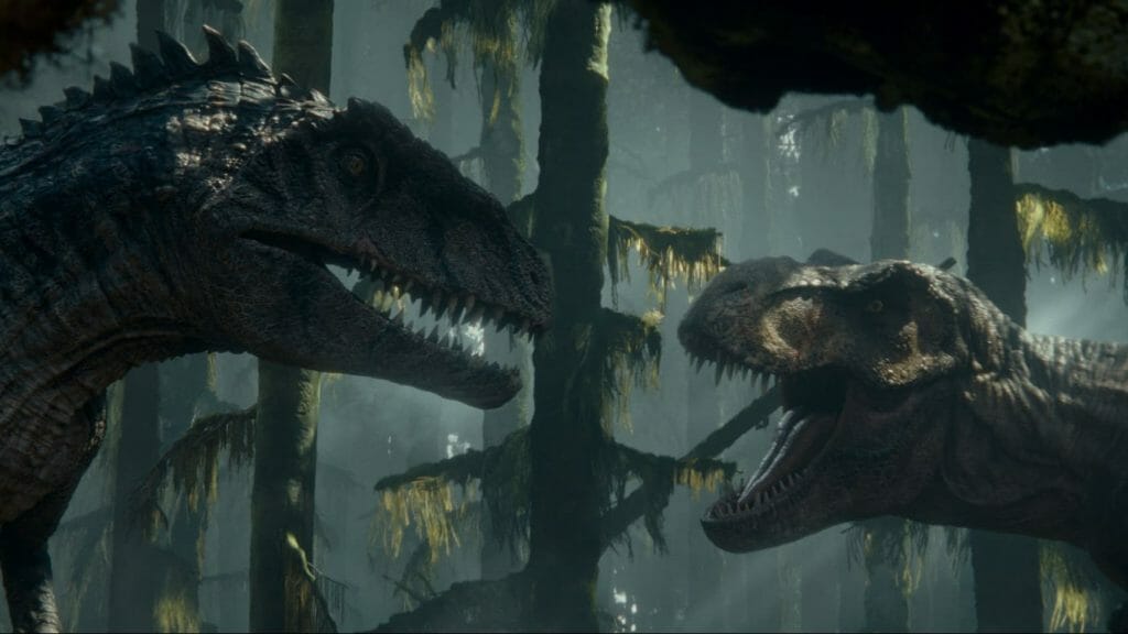 The new larger Giganotosaurus comes face to face with the iconic T. Rex in a dark forest in JURASSIC WORLD DOMINION directed by Colin Trevorrow and co-written by Emily Carmichael.