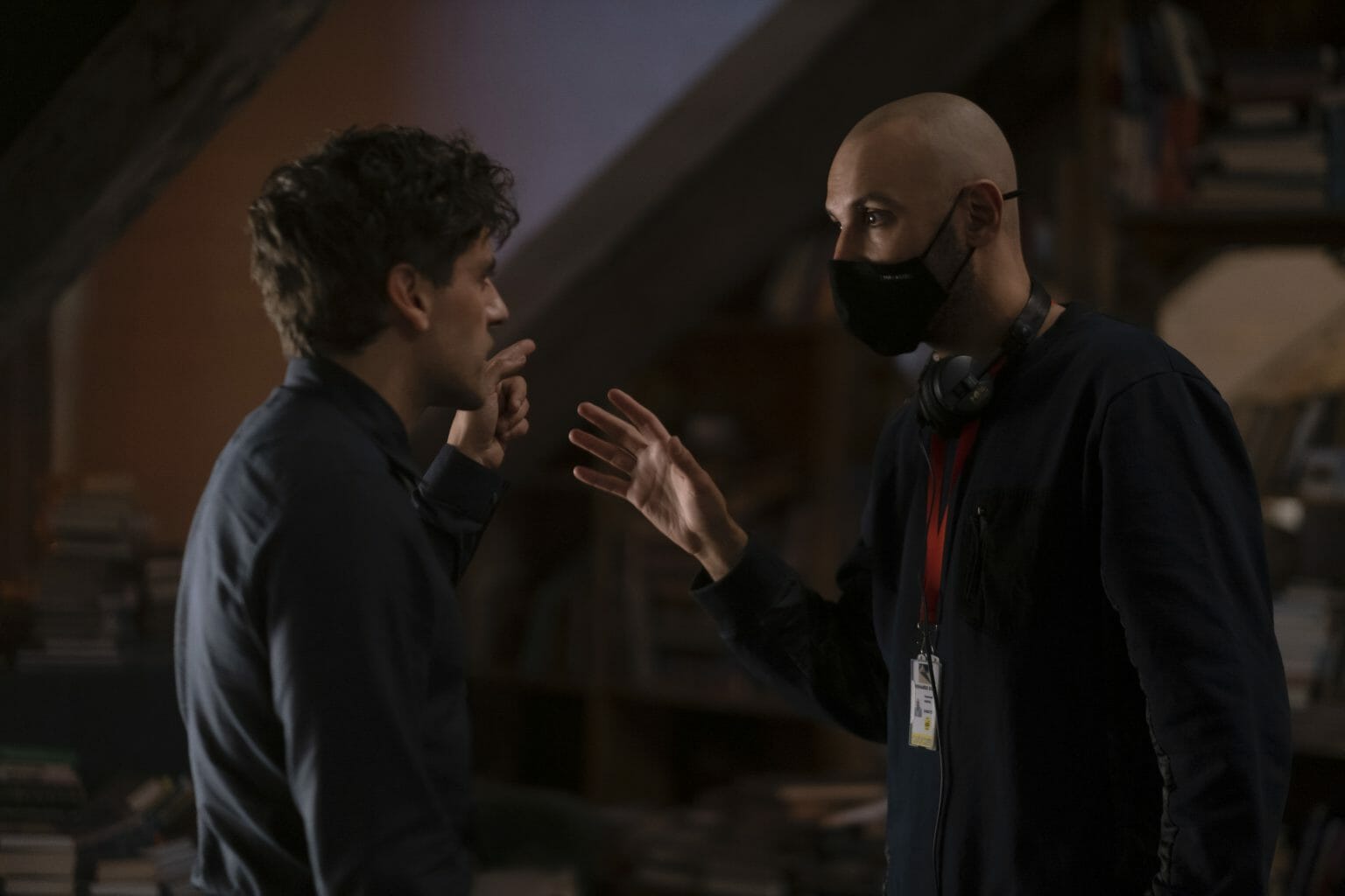 Director Mohamed Diab walks Oscar Isaac in costume as Steven Grant through a scene on the set of the MCU Disney+ series MOON KNIGHT.