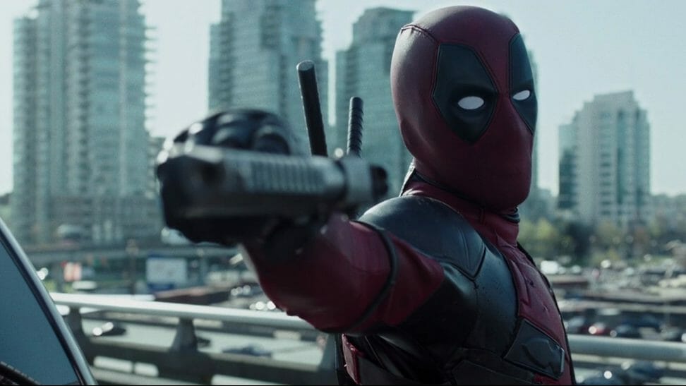 Deadpool holds up a gun sideways as he prepares to shoot as seen from the first film, with Deadpool 3 coming very soon next with production designer Raymond Chan.