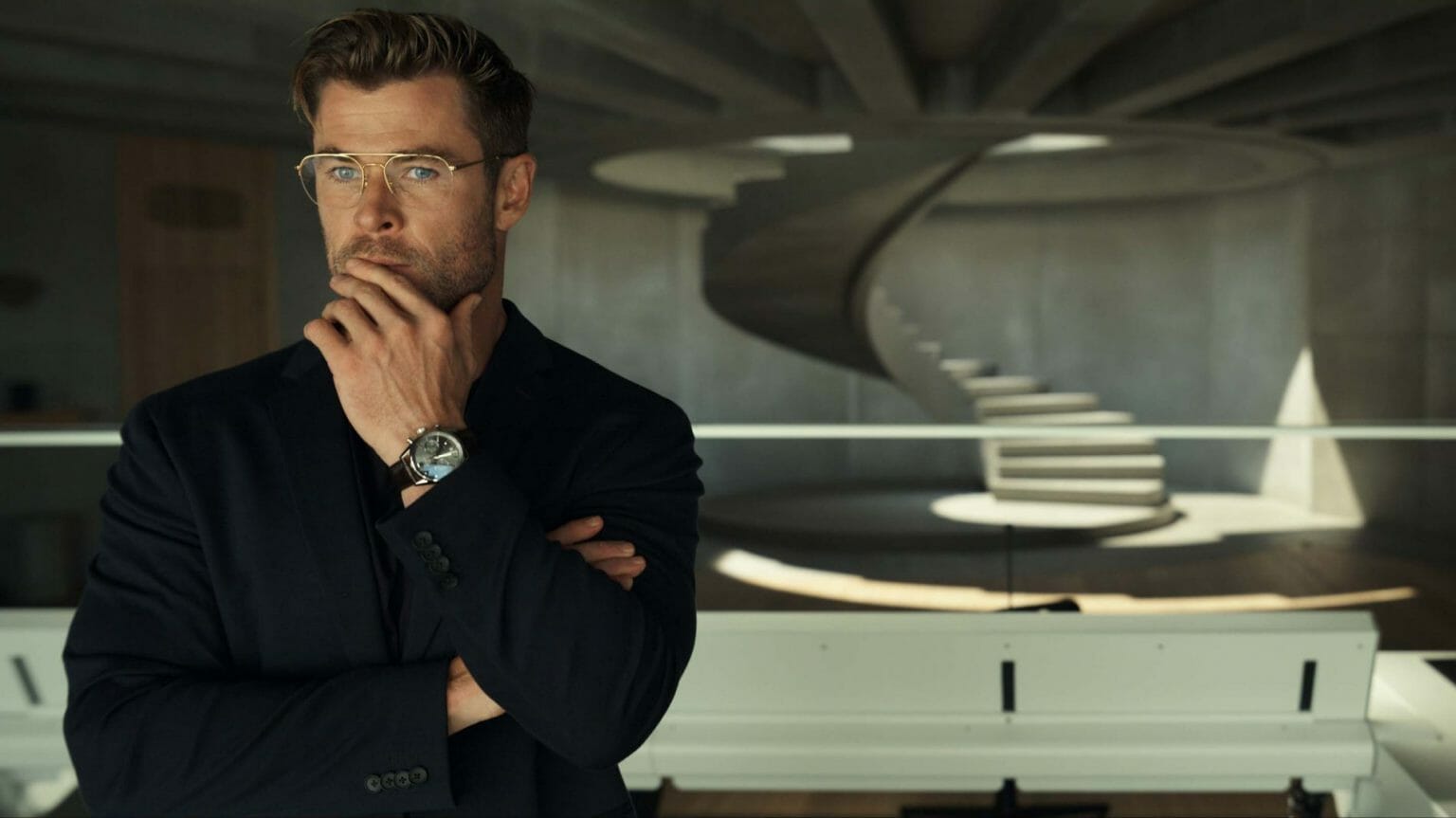 Chris Hemsworth in a black suit as the evil genius Abnesti in SPIDERHEAD on Netflix written by Rhett Reese and Paul Wernick.
