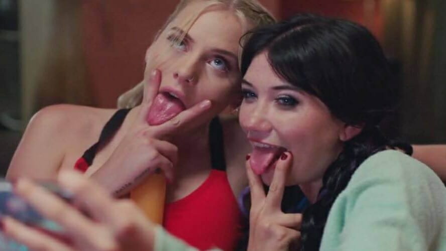 Sofia Kappel and Zelda Morrison take a crude selfie while sticking their tongues in between their fingers holding the V sign in PLEASURE written and directed by Ninja Thyberg.