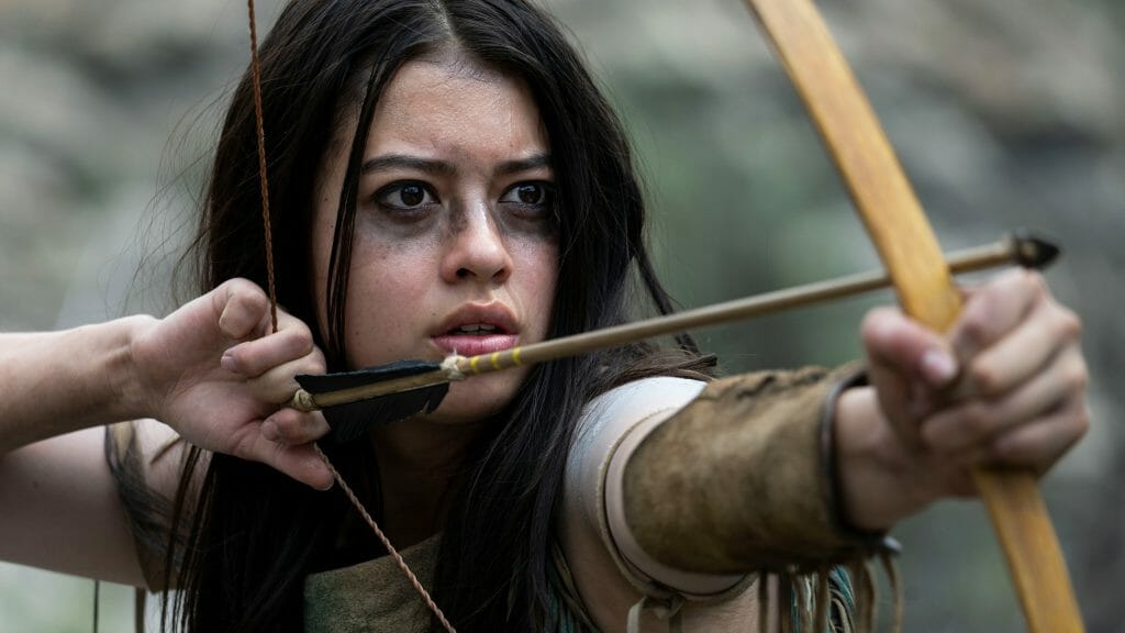 Amber Midthunder as the Comanche warrior Naru raises her bow and arrow for a shot in the physical stunt work on the Predator prequel PREY now streaming on Hulu.