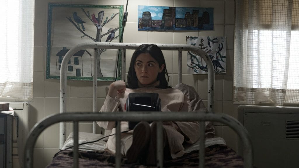 Esther played by Isabelle Fuhrman sits in her room filled with drawings and plans her escape from the Saarne Institute of Estonia in ORPHAN: FIRST KILL.