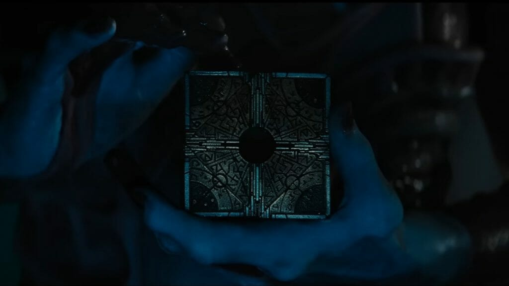 A close up shot of Pinhead's hands toying with and unlocking the iconic golden puzzle box in the HELLRAISER reboot streaming on Hulu.
