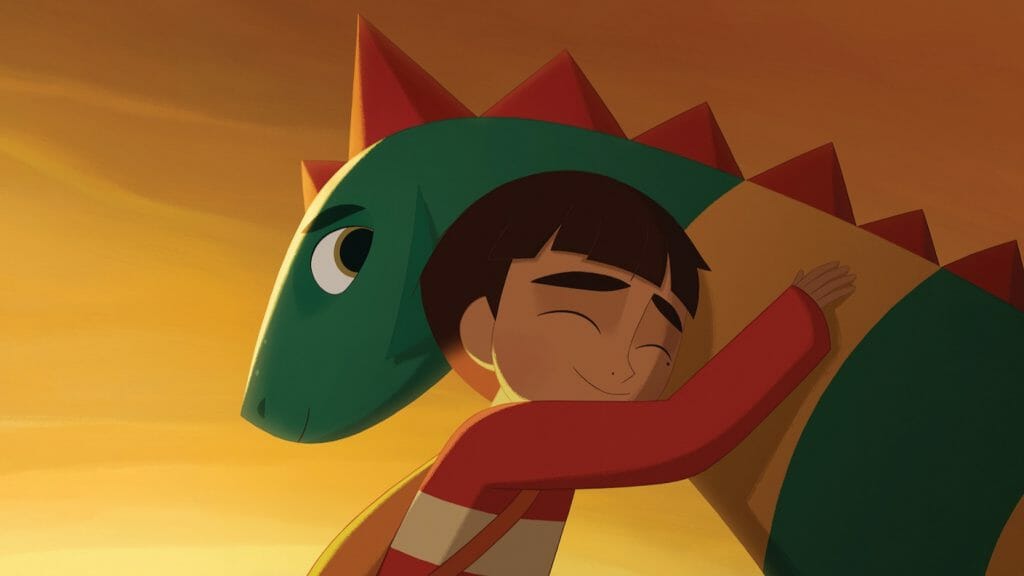 A young boy voiced by Jacob Tremblay gives a powerful hug to Boris the friendly young dragon Boris in MY FATHER'S DRAGON from Cartoon Saloon and Netflix animation.