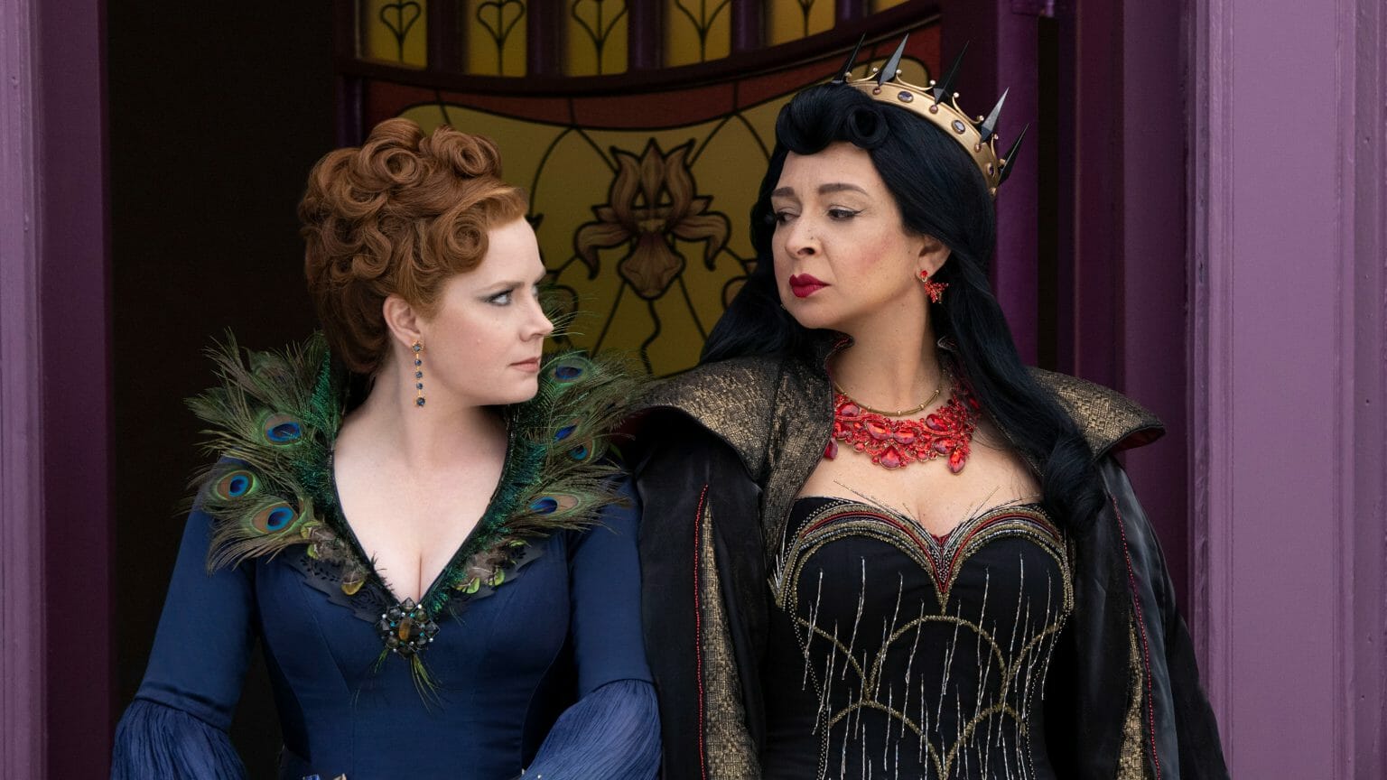 Amy Adams as Giselle in her cursed wicked stepmother costume next to Maya Rudolph as the evil Malvina Monroe in the live-action film DISENCHANTED streaming on Disney+.