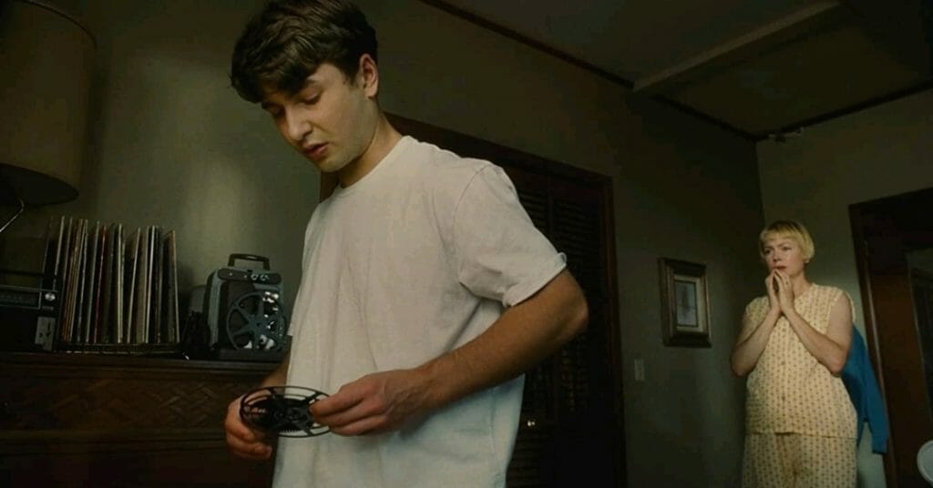 Gabriel LaBelle as Sammy Fabelman reveals a secret film reel to his mother played by Michelle Williams during an intense family argument from THE FABELMANS.