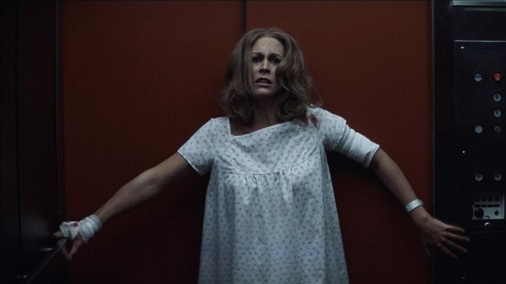 Jamie Lee Curtis escapes from Michael Myers in an elevator in the hospital chase scene from HALLOWEEN 2 (1981).