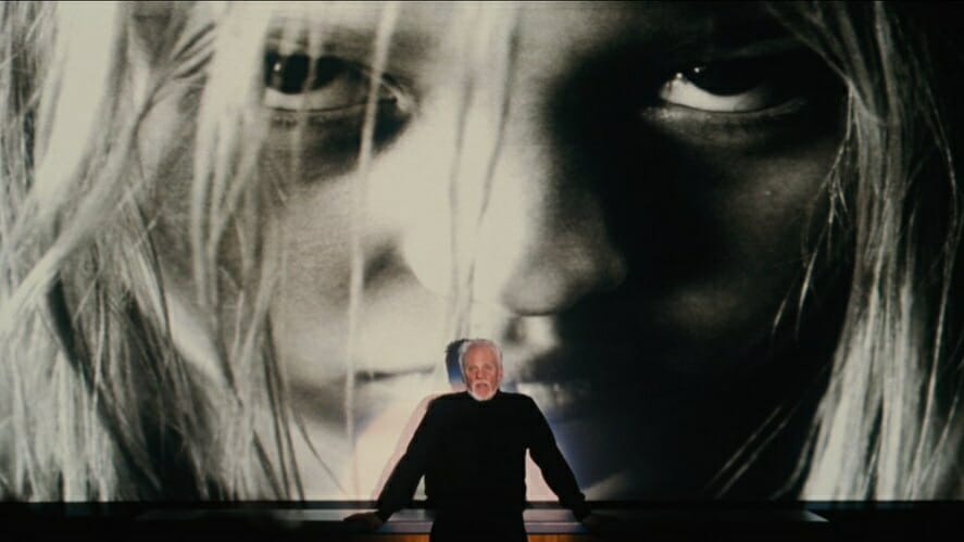 Malcolm McDowell as Dr. Loomis gives a lecture to students while a huge photo of young Michael Myers is projected in front of him in the 2007 Rob Zombie HALLOWEEN remake. 