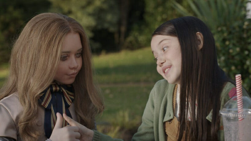 8 year old Cady played by Violet McGraw has a playful thumb war with her life-sized best friend doll M3GAN in the latest Blumhouse horror film.