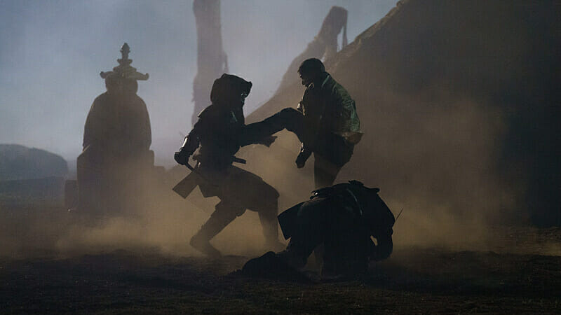Tyler Pose as Scott McCall fighting an Oni ninja in the middle of a foggy cemetery in TEEN WOLF: THE MOVIE on Paramount+.