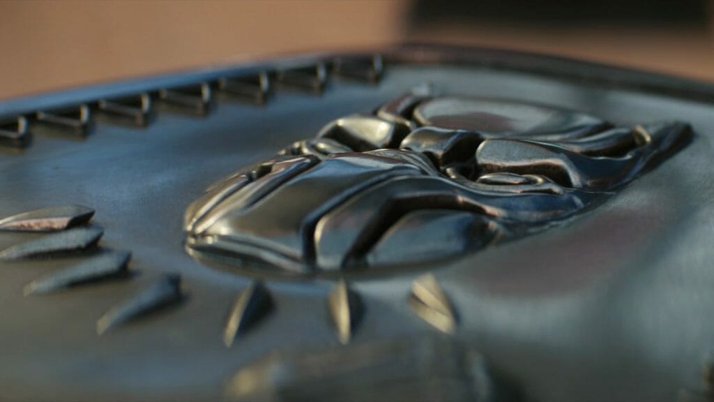 The Black Panther emblem on the metallic vibranium coffin of King T'Challa from the MCU film BLACK PANTHER: WAKANDA FOREVER, streaming on Disney+ in February 2023.