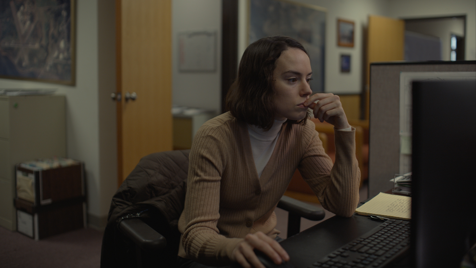 Daisy Ridley stars as the lonely Fran working at her mundane Oregon bay office in silence in the romantic dramedy feature film SOMETIMES I THINK ABOUT DYING.