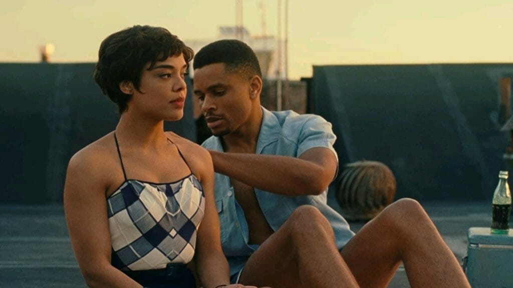 Tessa Thompson and Nnamdi Asomugha sit on top of a rooftop and stare at the sunset together in the period romance SYLVIE'S LOVE on Prime Video, one of our Valentine's Day films to stream for February 2023.