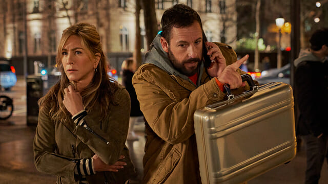 Adam Sandler and Jennifer Aniston star as the rookie detective married couple Nick and Audrey Spitz in MURDER MYSTERY 2 coming to Netflix in March 2023.